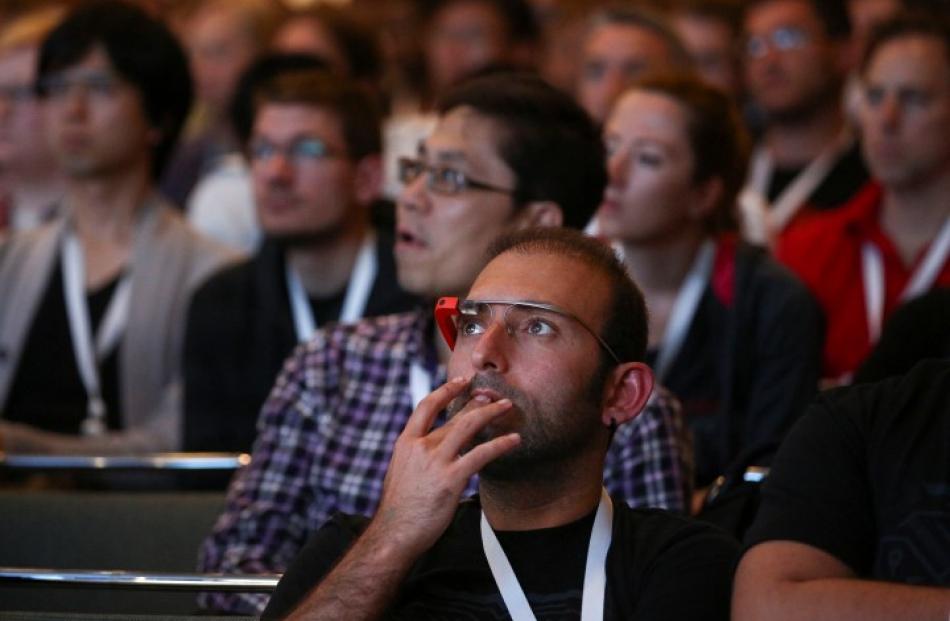 Google Glass-wearing attendees listen to a speaker in the 'Designing for Wearables' session at...