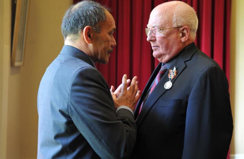 Governor-General Sir Jerry Mateparae congratulates Stewart Harvey after he received a Queen's...