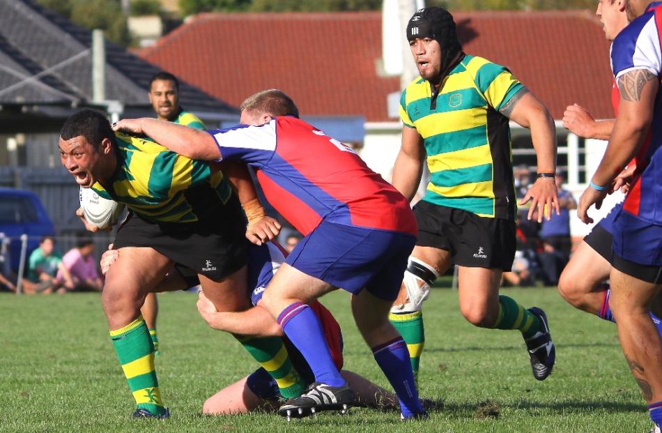 Green Island no 8 Mika Mafi attempts to break the Harbour defence at Watson Park.