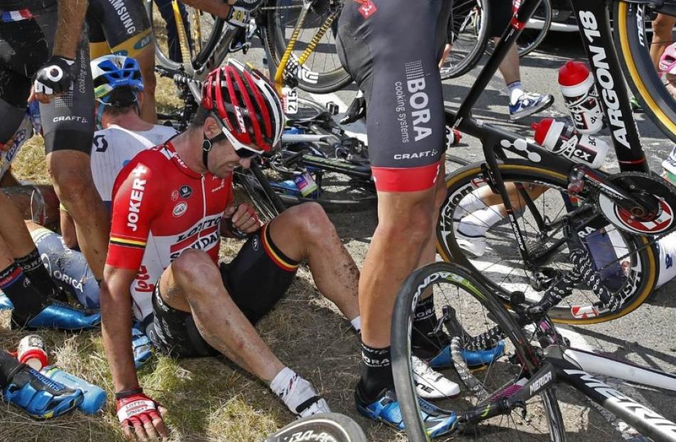 Greg Henderson sits amid the crashed bikes following the crash. Photo Reuters