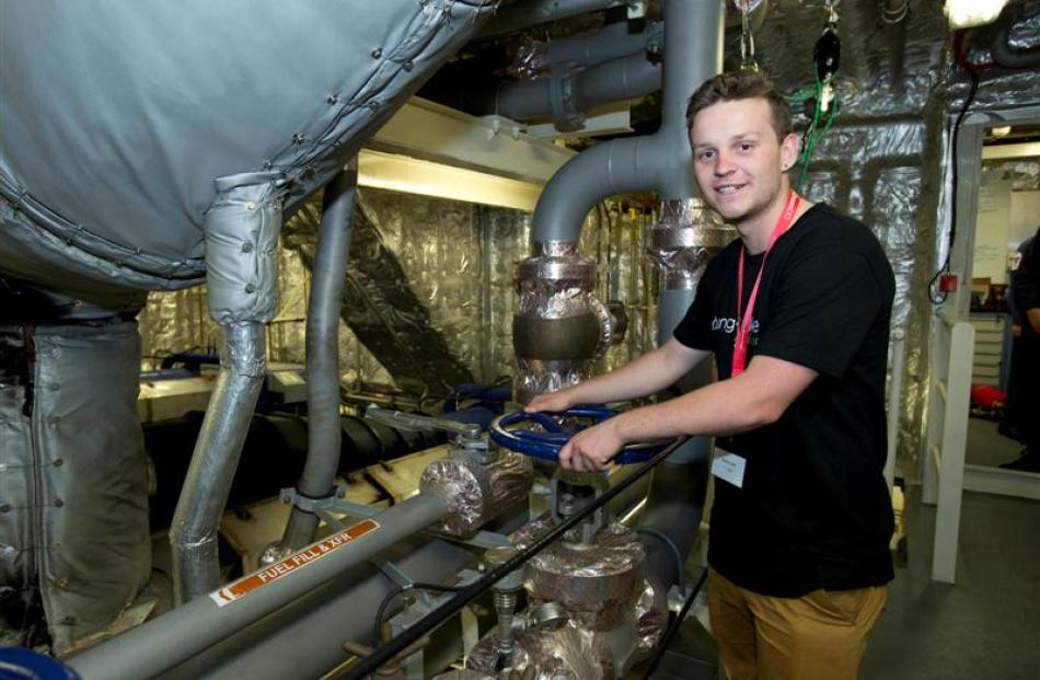 Hamish Lilley checks the engine room of  HMNZS Wellington during a recent  tour of the ship....