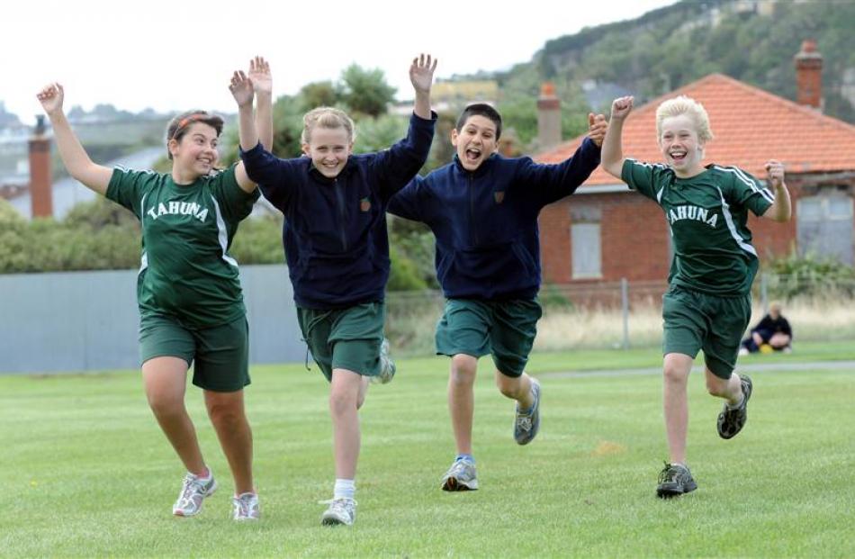 Happy to be back at school are (from left) Juliette Bernard (12), Georgia Cook (11), Dan Skaf (11...