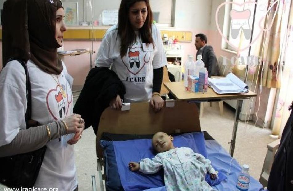 Icare founder Assil Russel (left) and Icare Iraqi director Shahad Ebadi visit an 8-month-old at...
