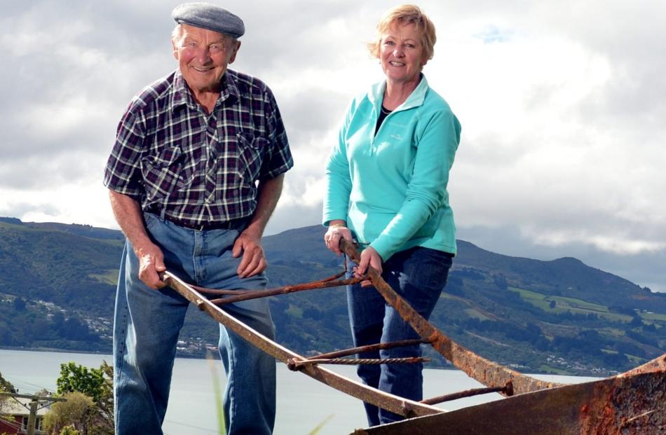 Harrison Hellyer and his late nephew’s wife, Mary, hold on to a swing plough on Bayside Farm, at...