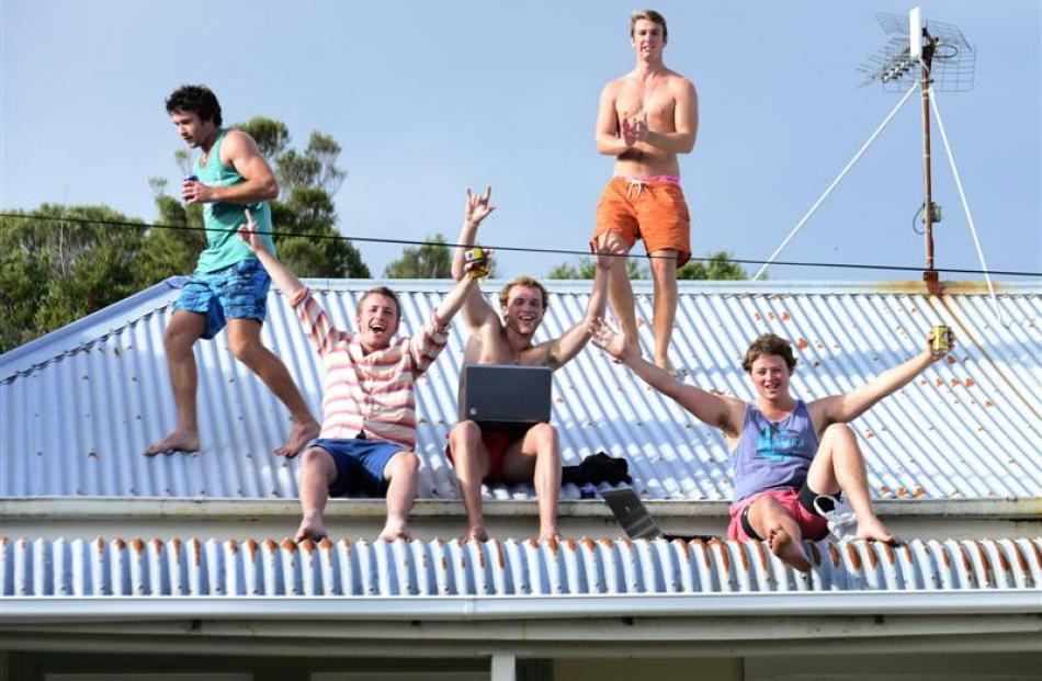 Having a blast on the roof of a Dundas St flat are (from left) Mitch Lalor (20), of Methven,...