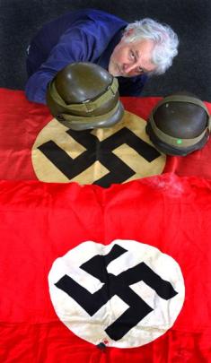 Hayward's Auction House co-proprietor Kevin Hayward shows some of the Nazi memorabilia being sold...
