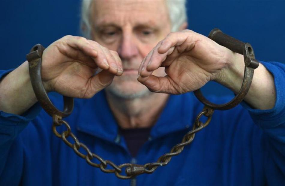 Hayward's Auction House owner Kevin Hayward holds shackles set for auction next week. Photo by...