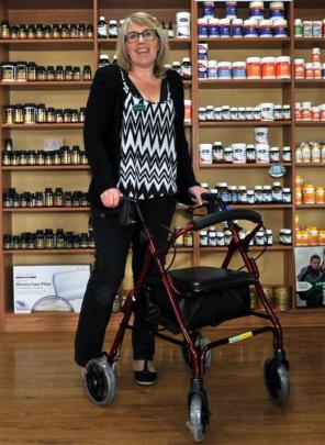 Health World Mosgiel owner Jan-Maree Anderson demonstrates a piece of mobility equipment for...