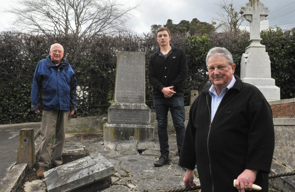 Helping to improve the damaged grave of early Dunedin surveyor Charles Kettle are (from left)...