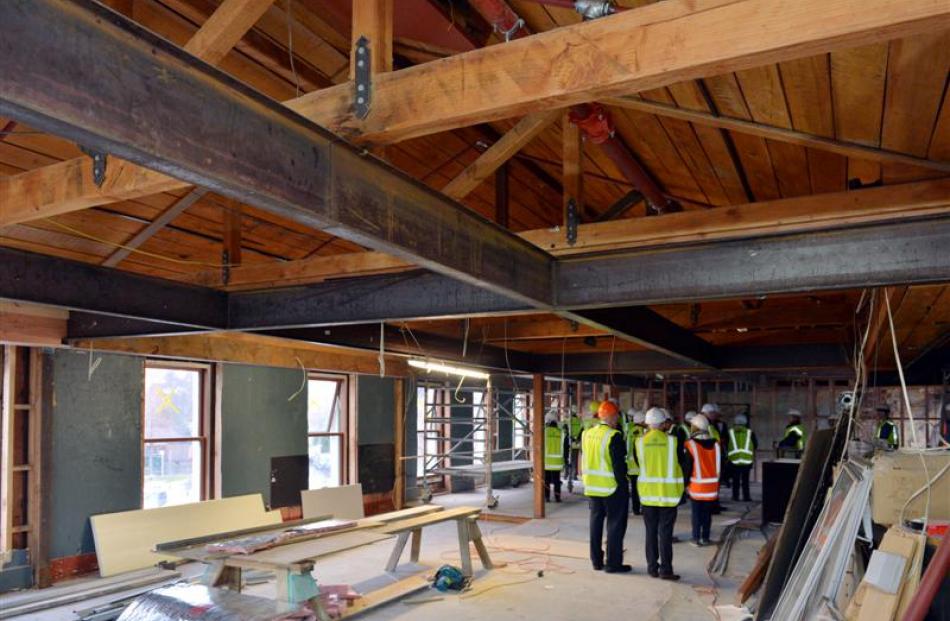 Heritage industry members yesterday look through the Captain Cook Tavern, which is being...