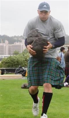 Highlanders fitness trainer Matt Dallow competes in the Carrying the Stones, in which he was...
