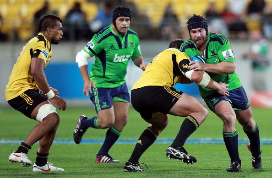 Highlanders hooker Andrew Hore tries to evade a tackle during the round four Super 15 match...