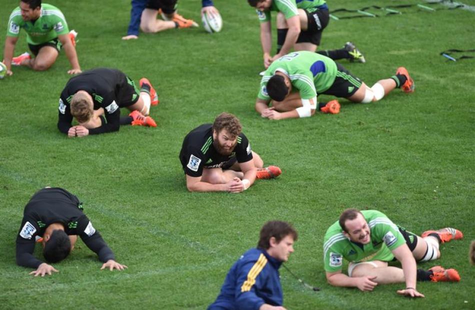 Highlanders hookerLiam Coltman (centre) stretches with team-mates before a training at Forsyth...