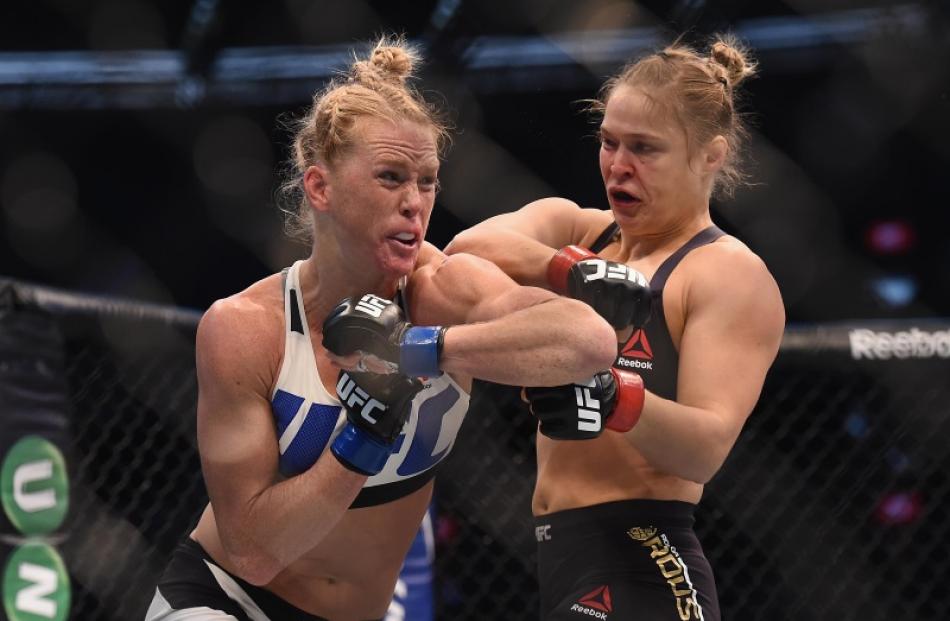 Holly Holm and Ronda Rousey during their fight in Melbourne yesterday. Photo: Reuters