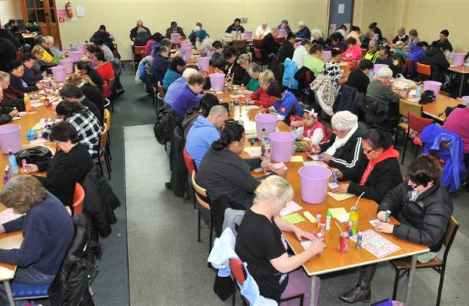 Housie players in South Dunedin mark their tickets as the numbers are called. Photos by Linda...