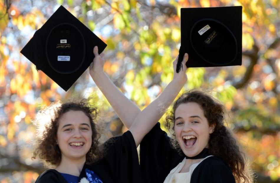 Identical twins Nyssa (left) and Hannah Payne-Harker (21)  prepare to graduate from the...