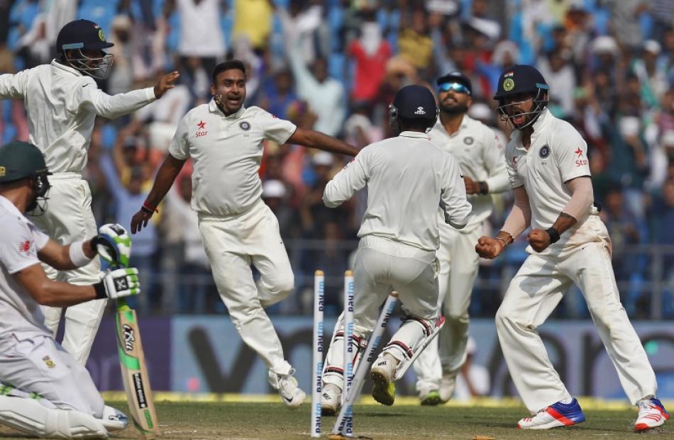 India's Amit Mishra (third from left) celebrates along with his captain Virat Kohli (right) after...