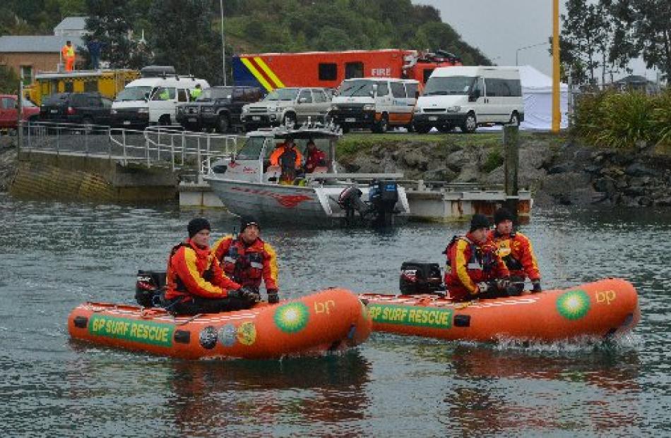 Inflatable rescue boat squad members (above, from left) Jamie Walters, Seth McPhee, Mark Whelan...