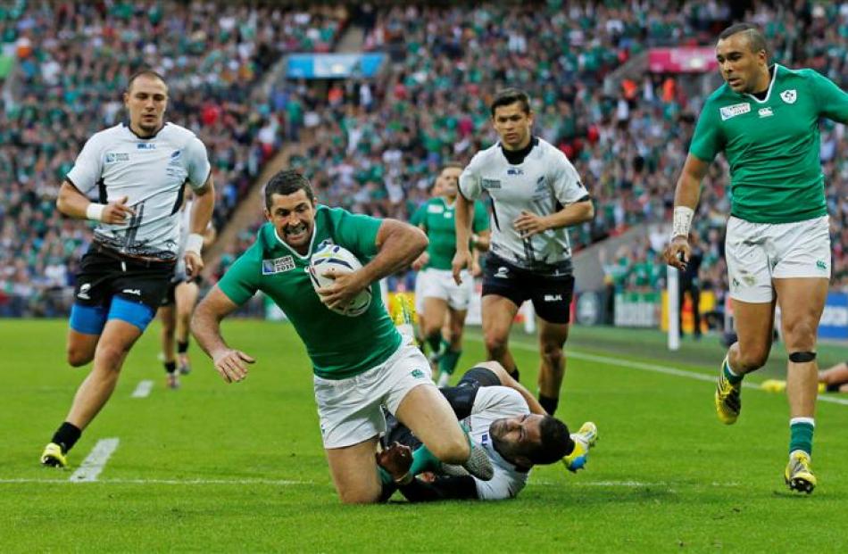 Ireland fullback Rob Kearney just prior to scoring their fifth try against Romania. Photo: Reuters