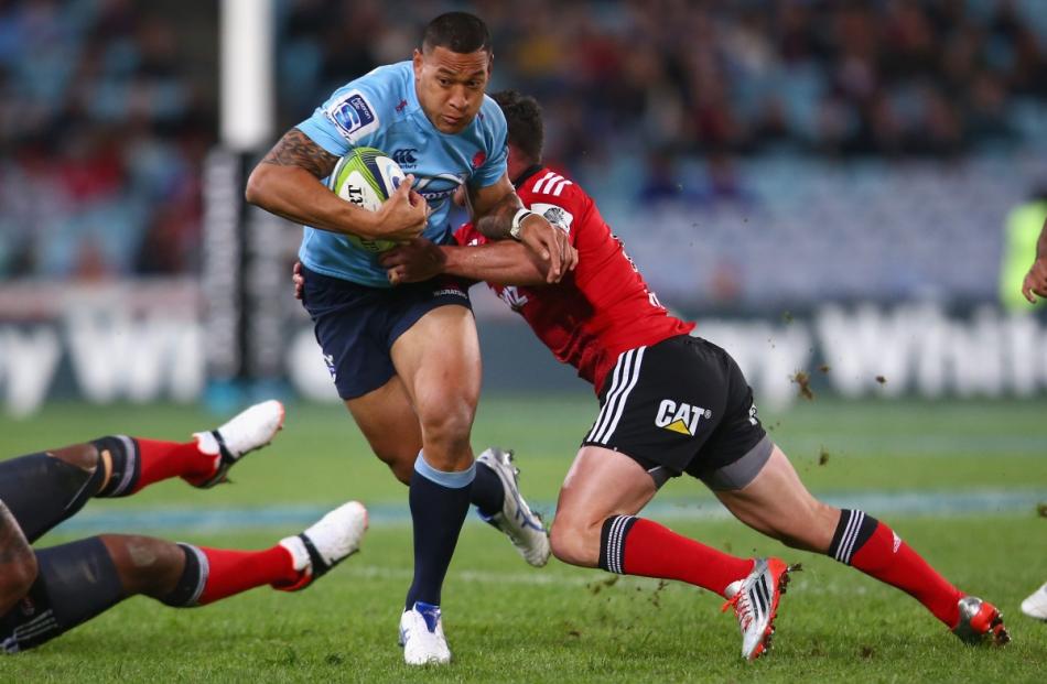 Israel Folau is tackled during the Waratahs game against the Crusaders. Photo by Getty Images.