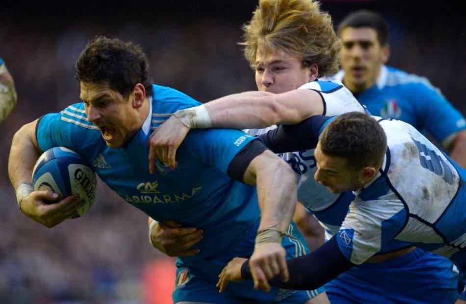 Italy's Alessandro Zanni scores a try despite the attentions of Scotland's David Denton and Greig...