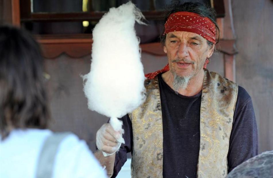 Ivan Berg hands out candy floss at the Gypsy Fair at the Oval in Dunedin yesterday.