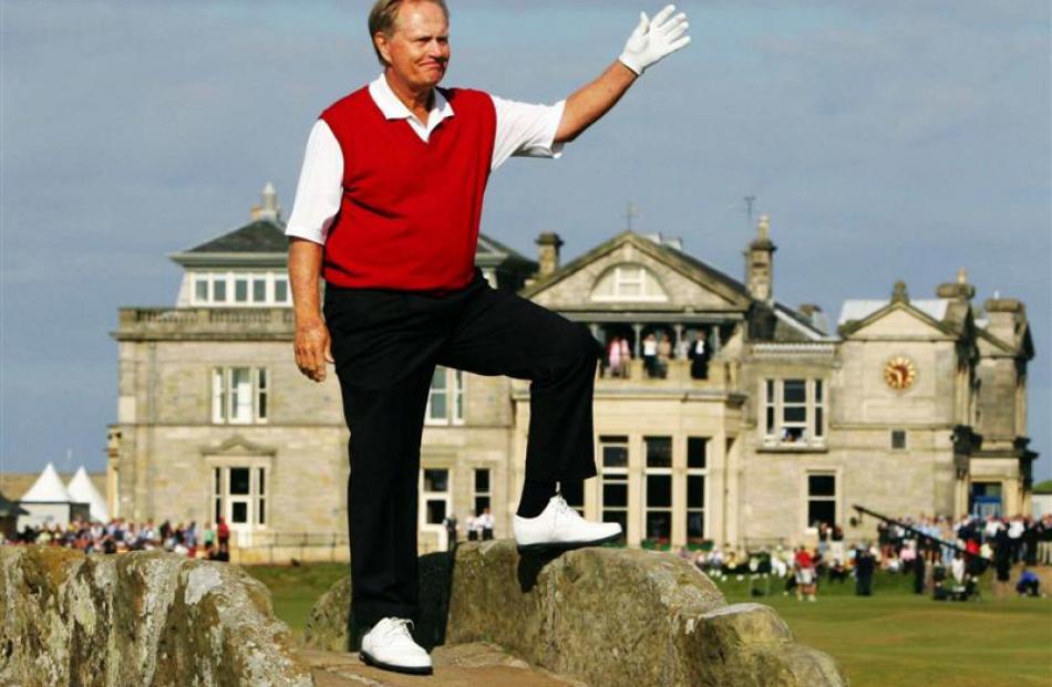 Jack Nicklaus waves to the crowd from Swilcan Bridge on the 18th fairway at St Andrews. Photo...