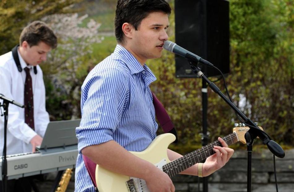 Jacobi Kohu-Morris, of Jake's Band, performs a B. B. King song during a lunchtime outdoor concert...
