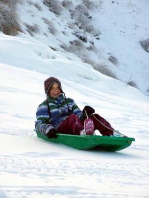 Jade Jenkins (12), of Tasmania, tries the new snow near the Coronet Peak base building yesterday.