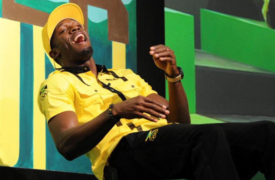 Jamaican sprinter Usain Bolt laughs during a team news conference in east London. REUTERS/Paul...