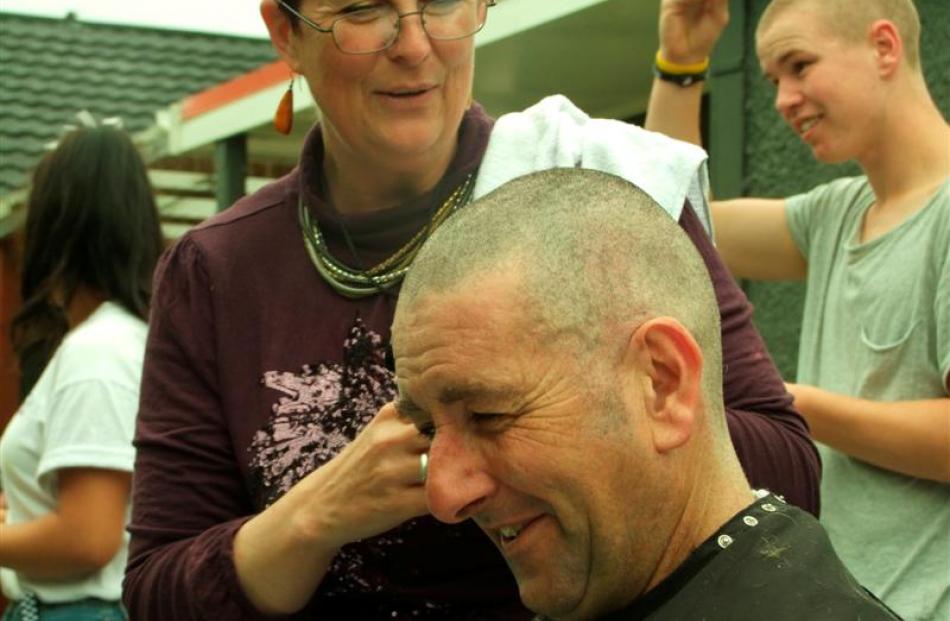 James Adam shows off the new look as helper Danielle Wass applies the finishing touches. Photo by...