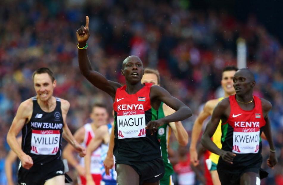 James Kiplagat Magut (C) crosses the line to win gold ahead of silver medallist Ronald Kwemoi and...