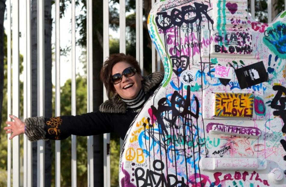 Janie Hendrix, half-sister of music legend Jimi Hendrix, poses by a guitar art installation on...
