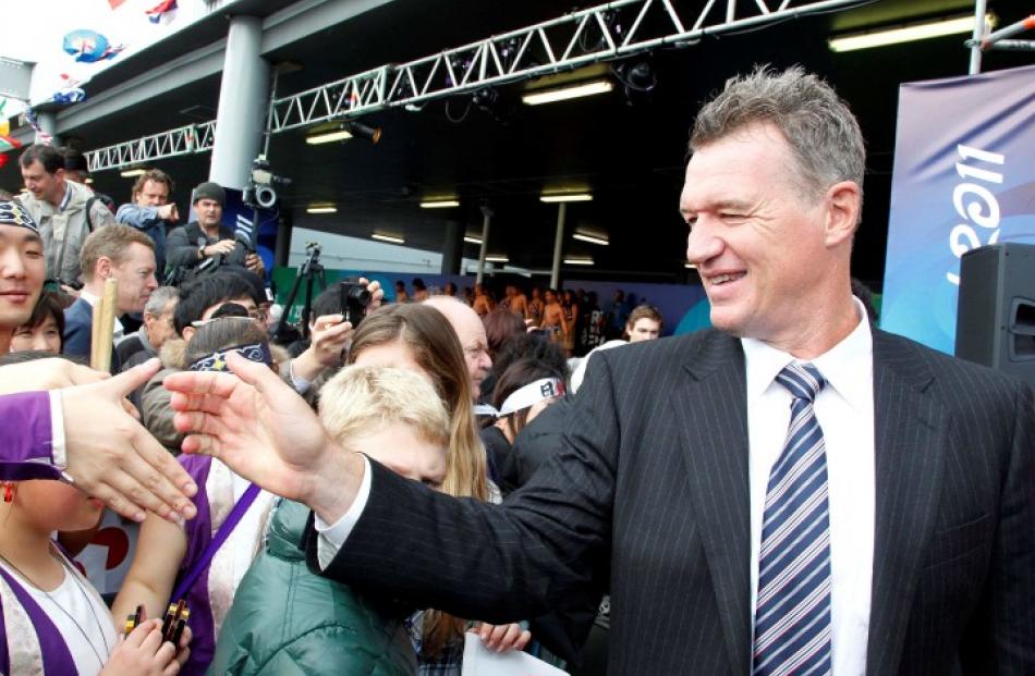 Japan coach, All Black great John Kirwan, greets well-wishers as his team arrives at Auckland...