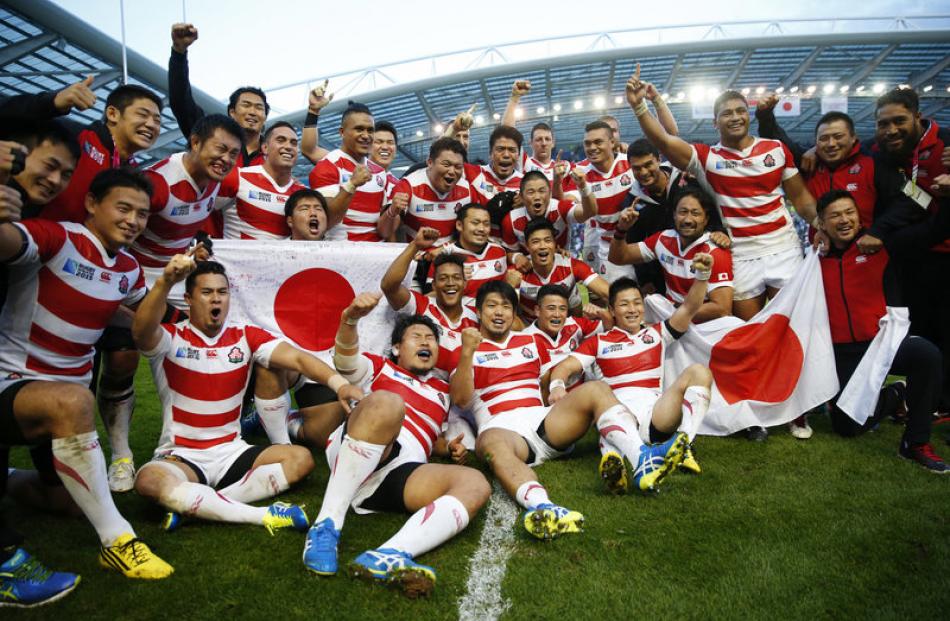 Japan players celebrate after their historic win over the Springboks. Photo: Reuters.