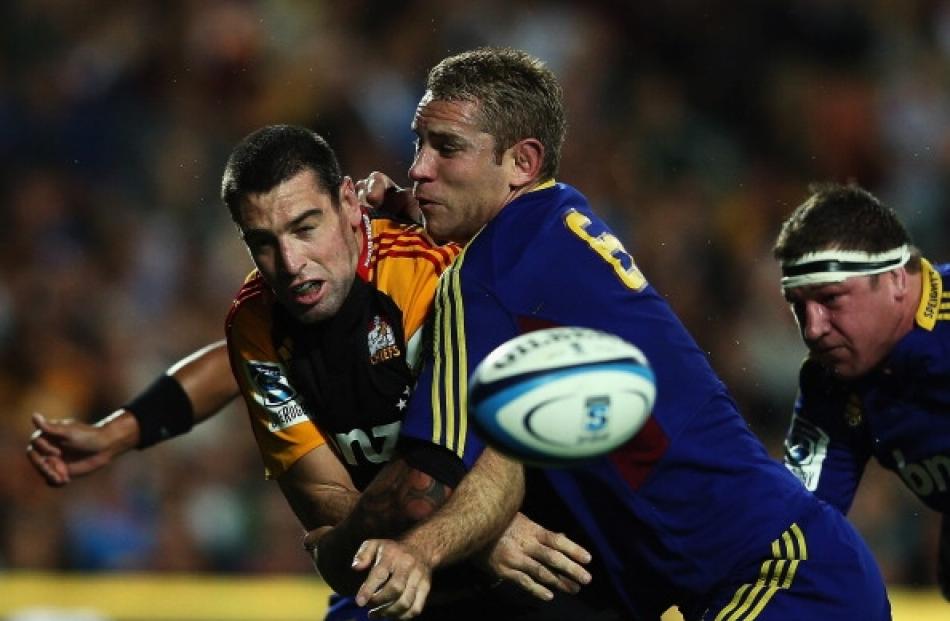 Jarrad Hoeata of the Highlanders tackles Nick Crosswell of the Chiefs during the round six Super...