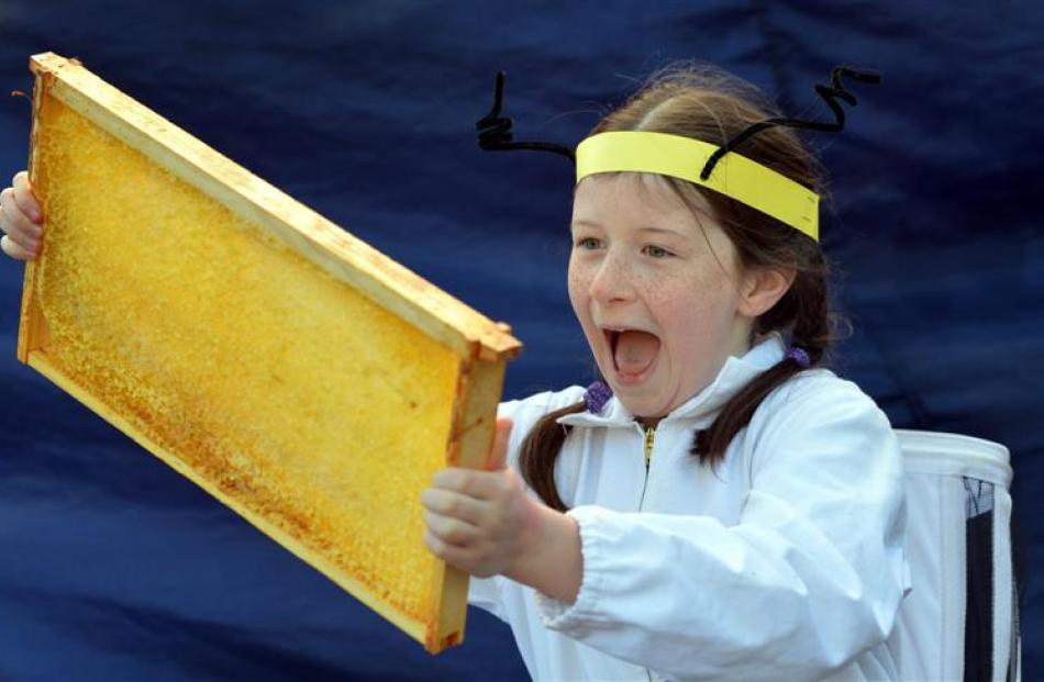 Jasmine Rixon (10) holds a honey frame at the Bee Expo at Otago Farmers Market at Dunedin Railway...