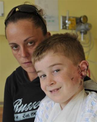 Jayden Taggart, with mother Carley Ludlow, puts on a brave face inside the childrens ward at...
