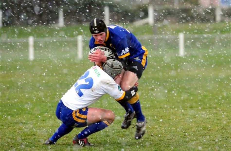 Jeremy Cave is tackled by Andrew Pararta at the Otago Air New Zealand Cup Trial teams game at the...