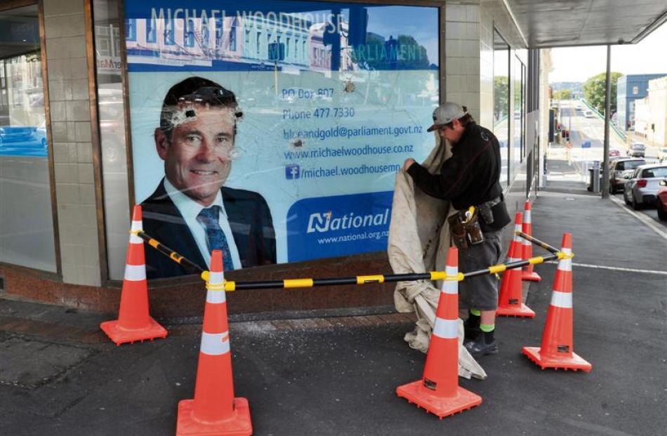 Jesse Brazil, of Thermawood Otago, cordons off an area  in  front of Michael Woodhouse's...