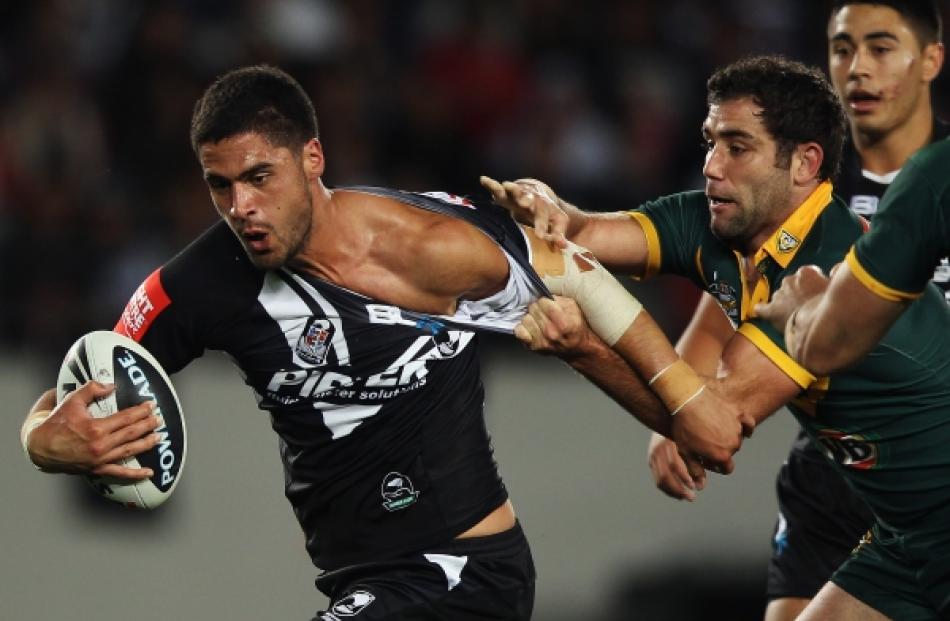 Jesse Bromwich of the Kiwis tries to get away from Cameron Smith of the Kangaroos during the...