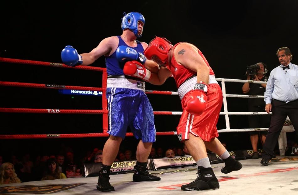 Jesse Ryder (left) knocks out Cameron Slater during Super8 Fight Night in Christchurch. Photo by...