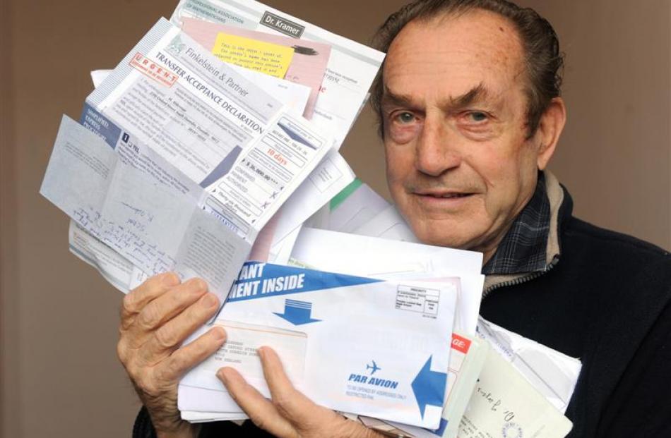 John Alderman (85) holds some of the scam mail he gets daily in his South Dunedin letterbox....