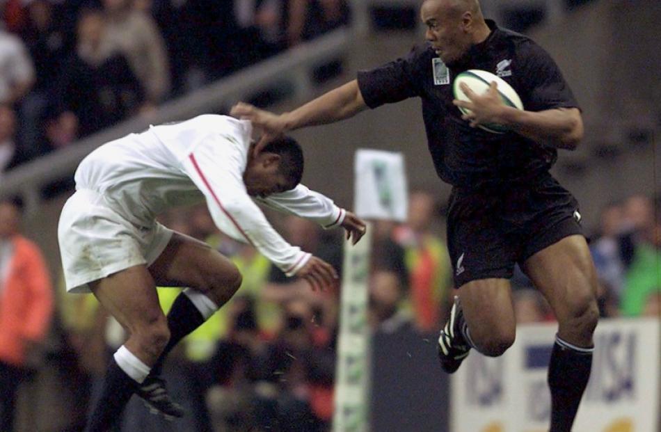 Jonah Lomu swats aside Jeremy Guscott en-route to scoring his magnificent try against England at...