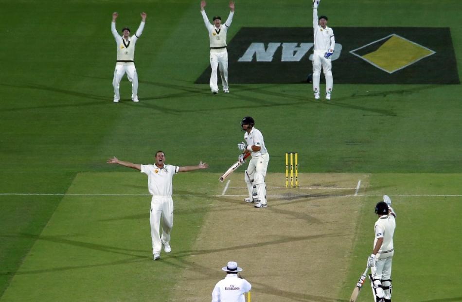 Josh Hazlewood celebrates as Ross Taylor is dismissed during the night session on day two of the...