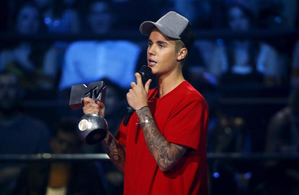 Justin Bieber accepts one of his five awards. Photo: Reuters
