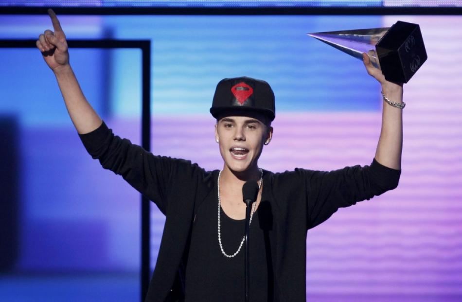 Justin Bieber accepts the award for favorite pop rock album for 'Believe' at the 40th American...