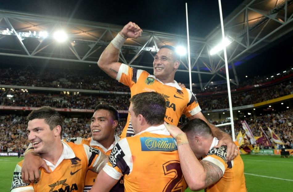 Justin Hodges of the Broncos and team mates celebrate victory after the NRL First Preliminary...