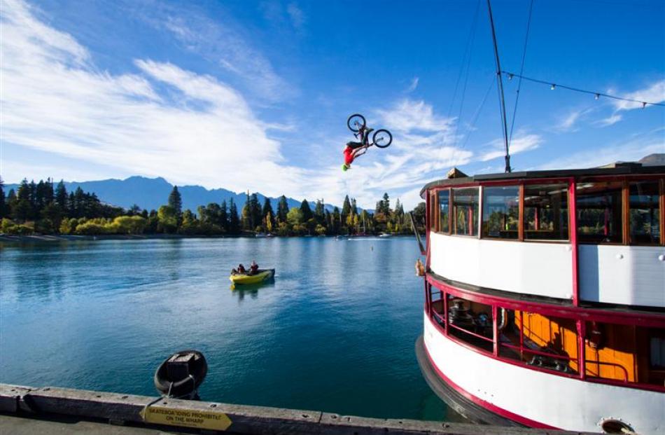 Kelly McGarry performing a backflip on his bike from the roof of the TSS Earnslaw.