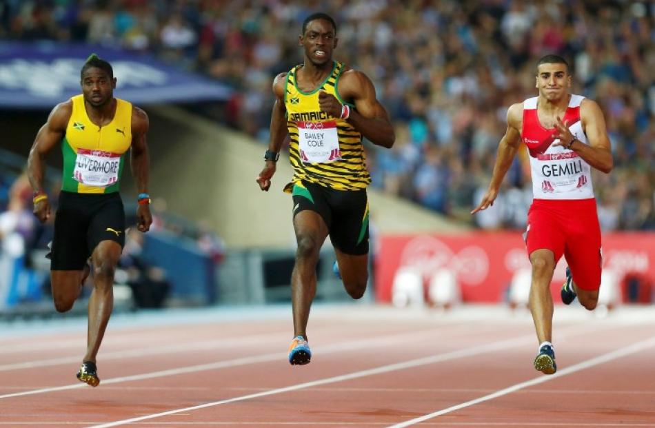 Kemar Bailey-Cole (C) finishes first ahead of Adam Gemili (R) and Jason Livermore in the men's...